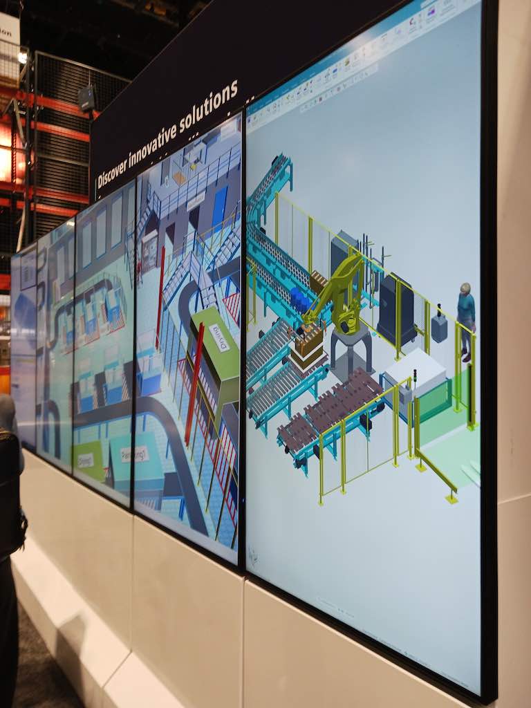 A wall of giant flat screen at ProMat 2023 demonstrates integrated intralogistics capabilities, including virtual commissioning, from Siemens. Courtesy: Mark T. Hoske, Control Engineering