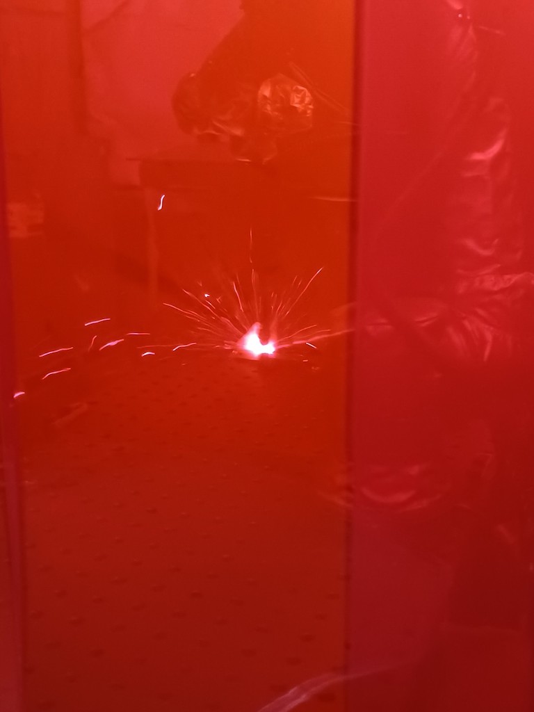 Universal Robots’ collaborative robot in a Vectris Automation welding workcell welds behind a safety curtain at Freedman Seating Co. Courtesy: Mark T. Hoske, Control Engineering