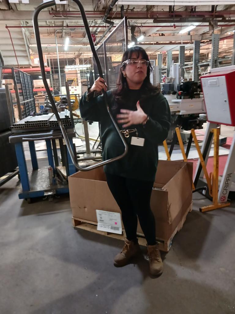 Freedman Seating's Karen Arroyave shows formed seat tubes prior to final bending. Courtesy: Mark T. Hoske, Control Engineering