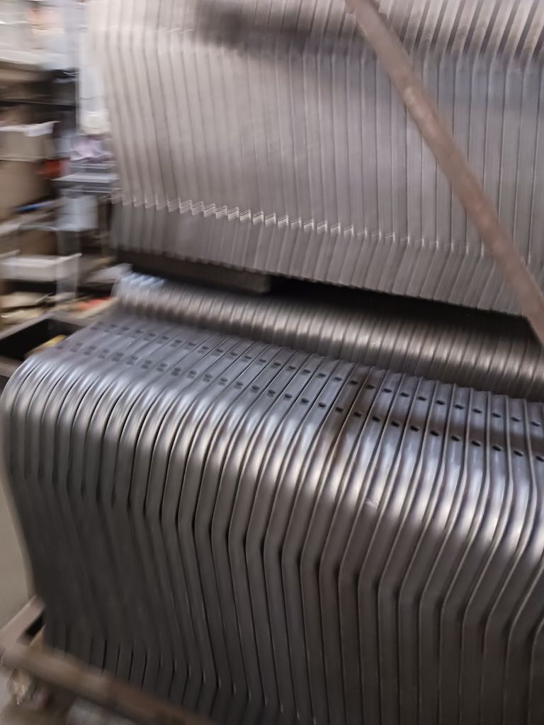 Stack of bent seat tubes looks like folding chairs at Freedman Seating. Courtesy: Mark T. Hoske, Control Engineering
