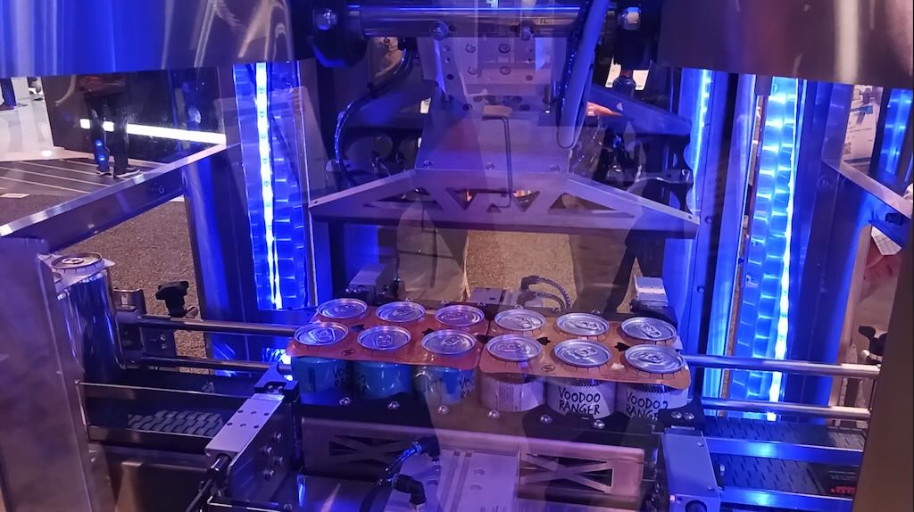 This redesigned Codi machine, now using electric controls instead of pneumatics, added efficiency, reliability and flexibility, as shown at the Festo Corp. booth at Pack Expo Las Vegas 2023. The six-pack rings (also called handles or yokes) that were just applied two at a time to cans are made with sustainable (biodegradeable materials). 