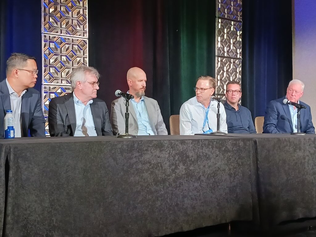 Figure 14: Six experts discuss open process automation benefits, with questions and answers from Harry Forbes, ARC (not shown) and the audience at 2024 ARC Industry Forum. The OPA experts, left to right, are Robert Tulalian, IT-OT convergence global program manager, Global Shell Solutions; Don Bartusiak, president of Collaborative Systems Integration; Brad Mozisek, program manager, Wood OPA center of excellence; David Campain, global manager for process control systems for FLSmidth; Renato Pacheco Silva, CEO, Aimirim; and Dave DeBari ExxonMobil leader of openplus automation program. 
