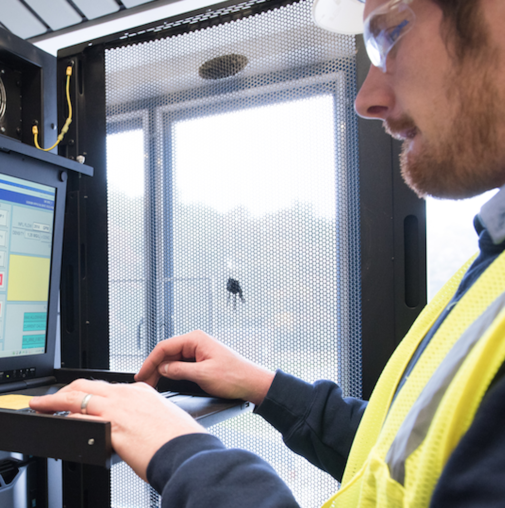 Figure 1: A control systems engineer works on a human machine interface/supervisory control and data acquisition system server. Courtesy of CDM Smith.